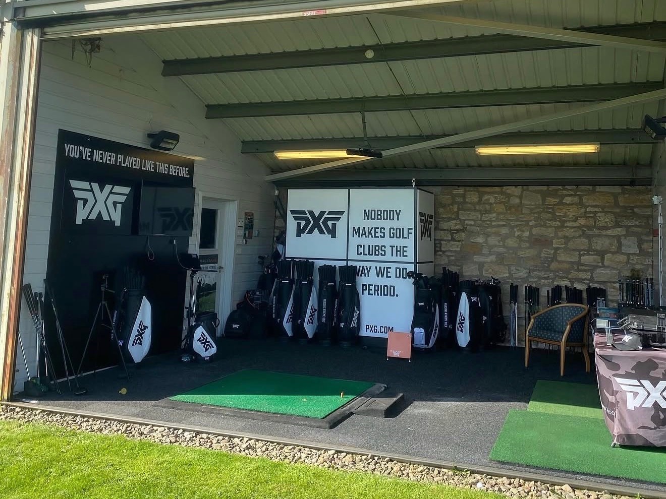 The PXG custom fitting bay at Kings Acre, with PXG bags, clubs and a hitting mat